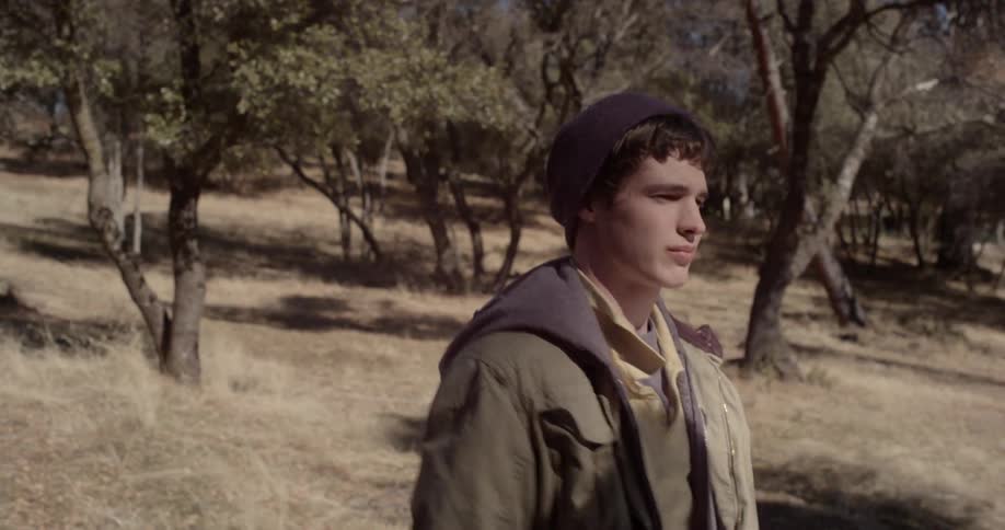 A man is walking through the woods