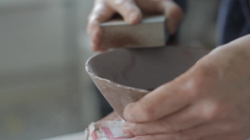 A woman is making a bowl