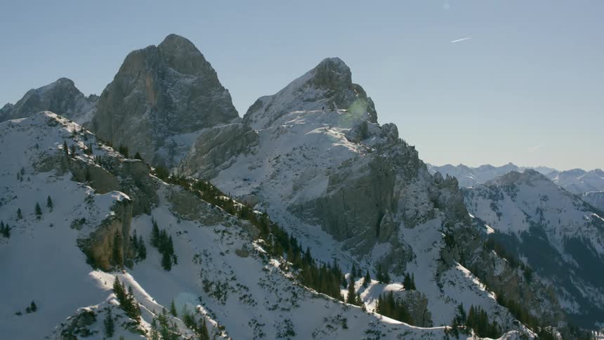 Snow covers rocky mountain peaks