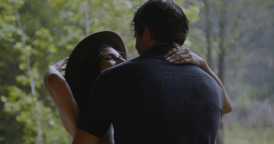 A man and woman hug in the rain