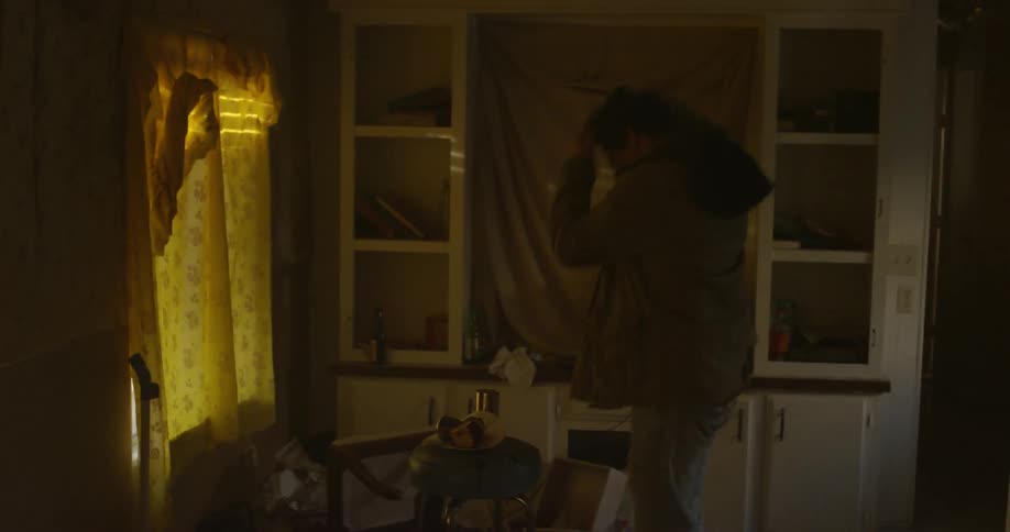 A young man walks into a home and throws objects around