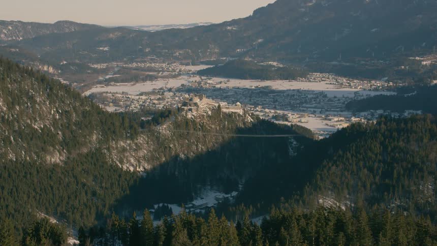 Tall trees cover the mountainous landscape