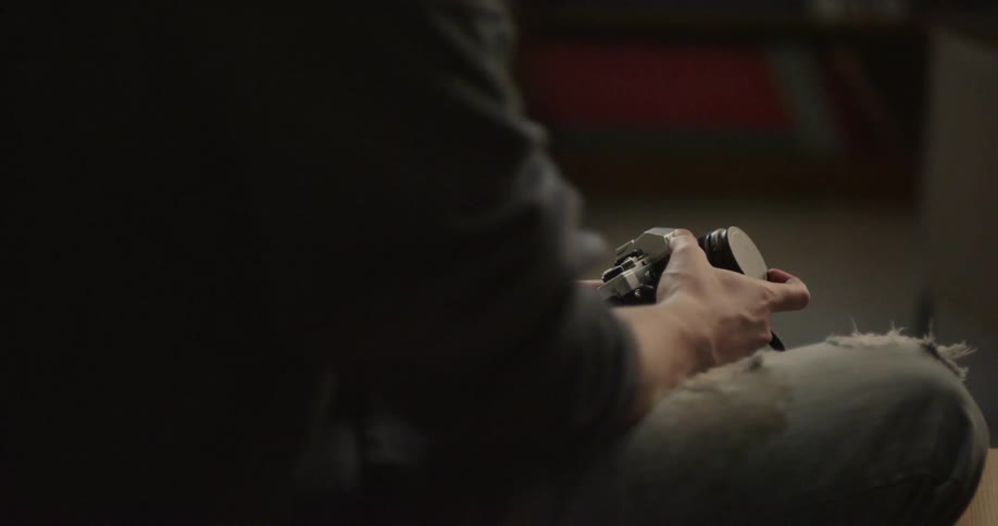 A man is sitting holding his camera