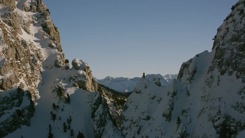 Snow covers a rocky mountain ridge