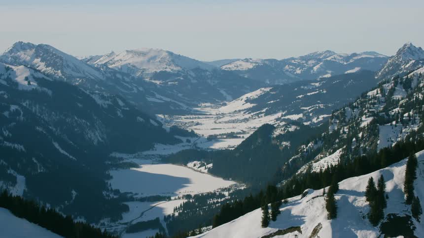 Snow covers mountains on a clear day