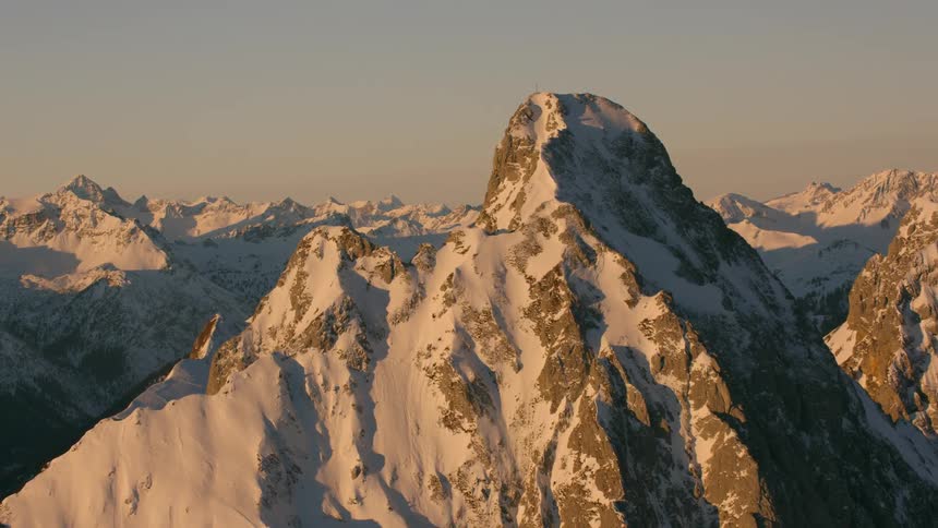 Snow covers a rocky mountain peak