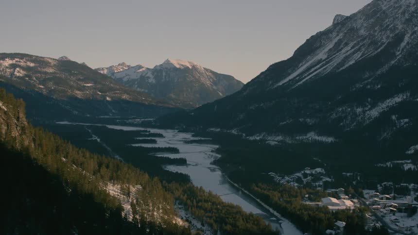 A river flows through snowy mountains
