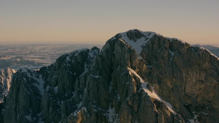 Snow covers a stone mountain