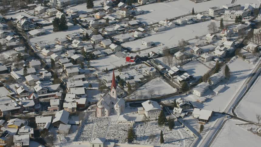 The town below is covered with snow