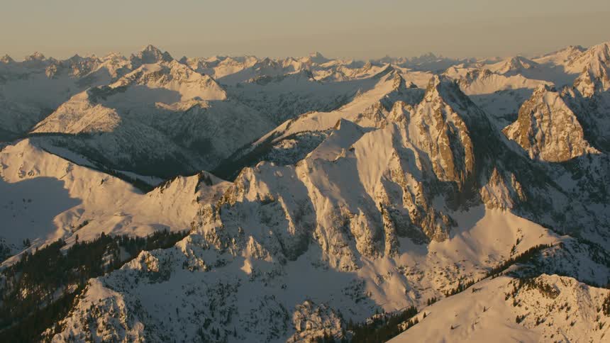 Snow covered mountain range is viewed from the air