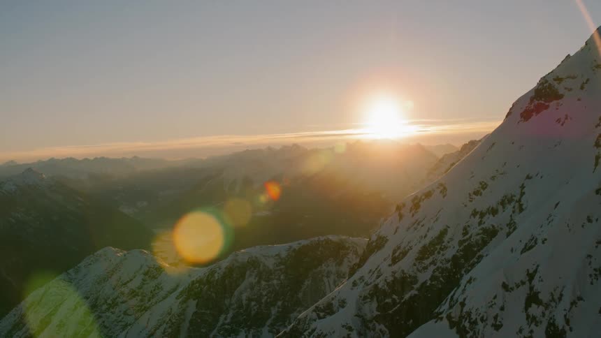 The sun rises over mountains