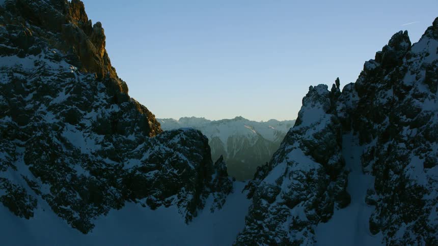 Jagged mountain peaks partially covered in snow