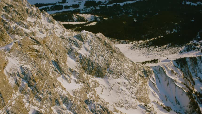 The mountain slowly slants down covered with snow