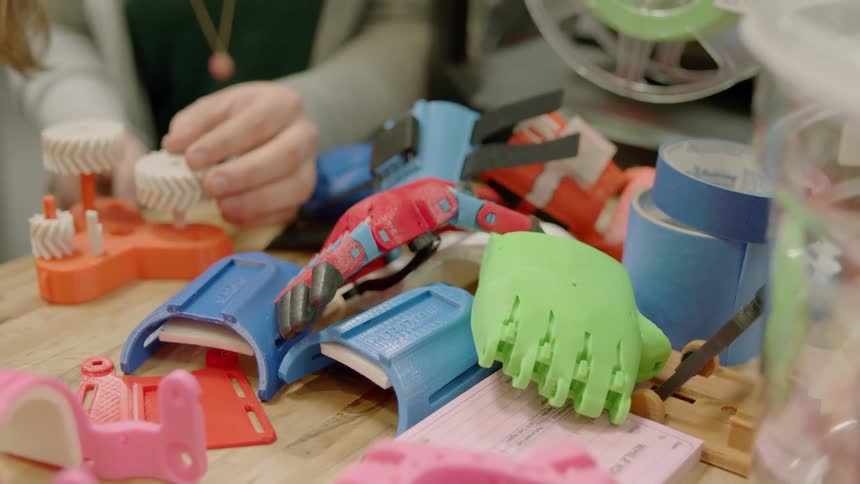 A child is putting wheels on a toy