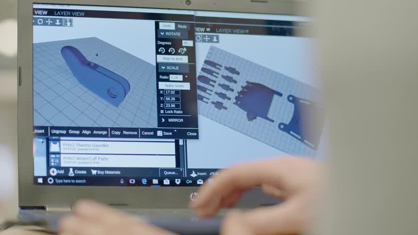 A man uses a cad software program on a laptop