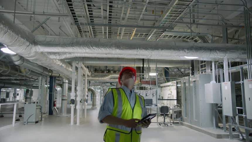 A worker walks through a factory