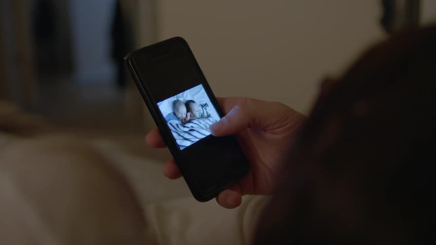 Someone is looking at baby photos on a phone