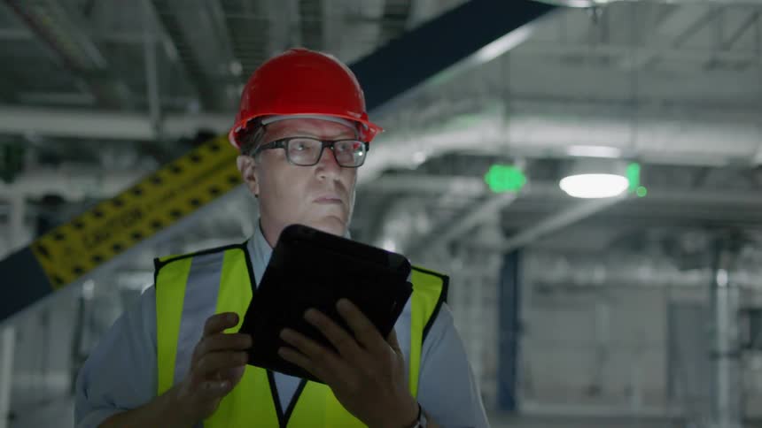 A construction worker inspects a building