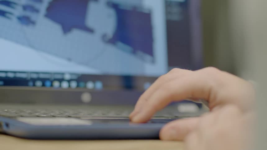Person scrolls on laptop tracking pad