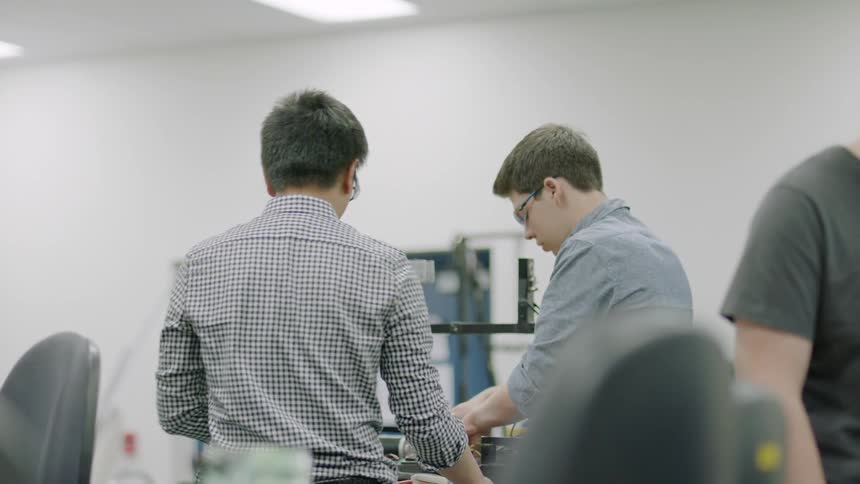 Children work on electronics in a classroom