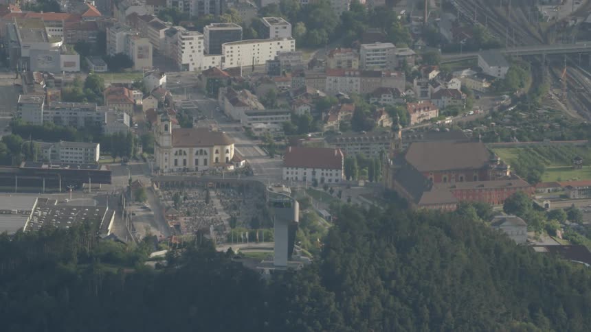 A tower stands on top of a hill overlooking the city