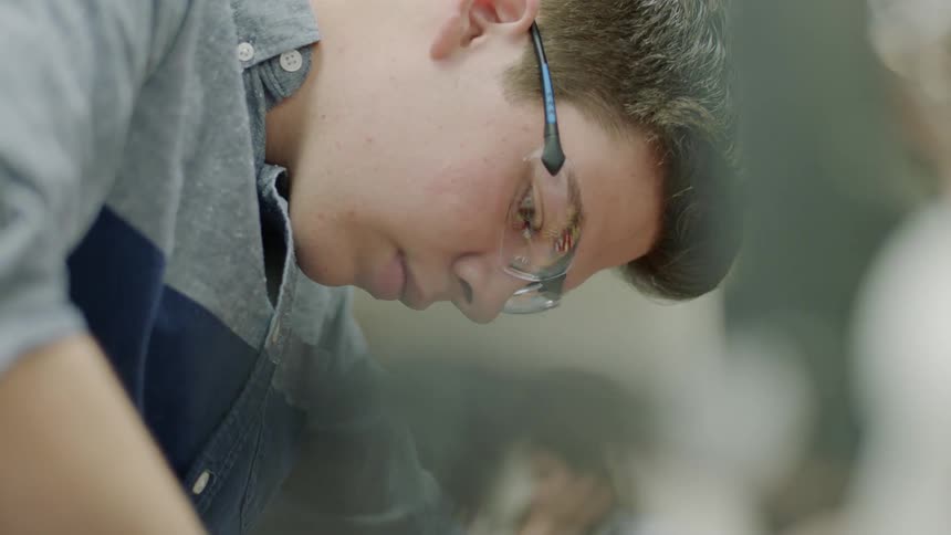 Man wears safety goggles in workshop