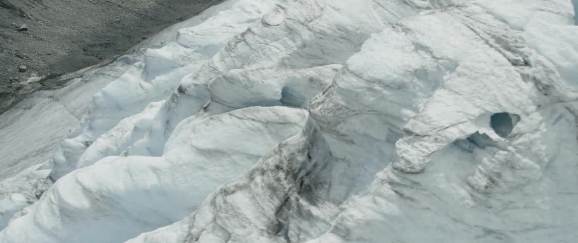 Piles of snow cover a mountainside