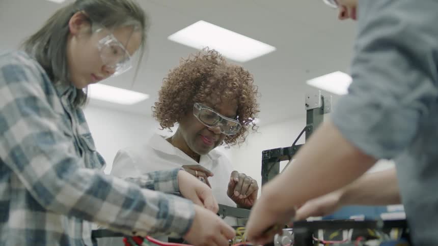 Young people work on electronics
