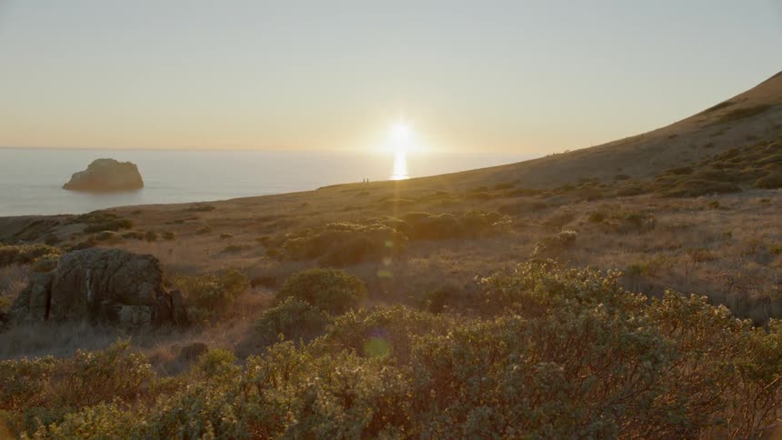 The sun is setting of a coastline