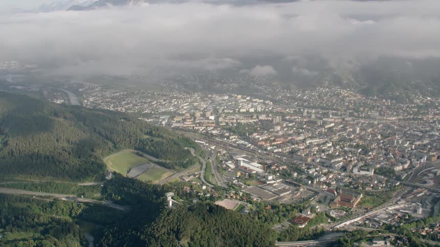 Fog hangs over innsbruck with tilt down to the Bergisel ski jump