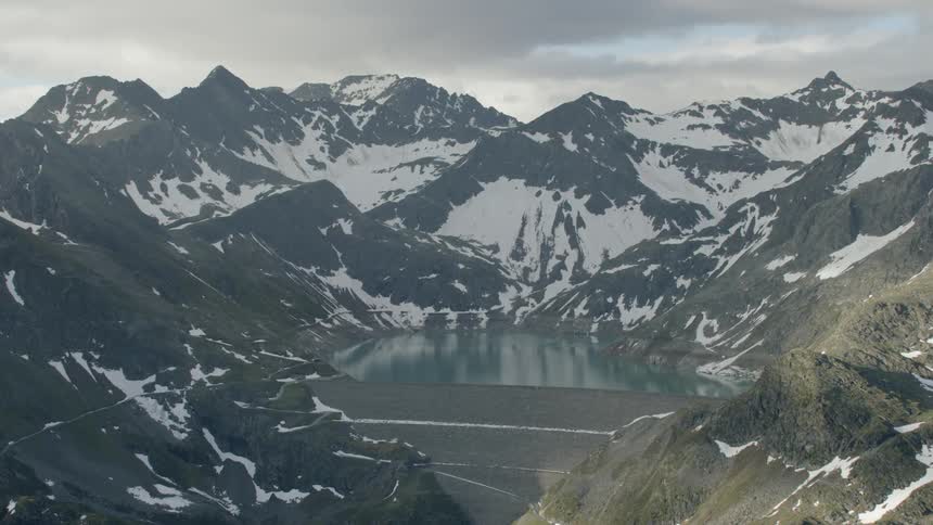 Snowy mountains surround a lake