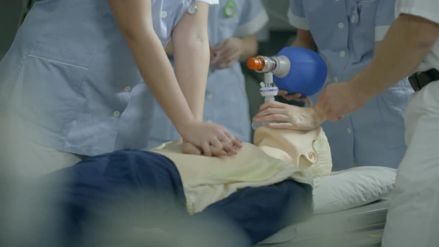 Technicians practice cpr on a dummy