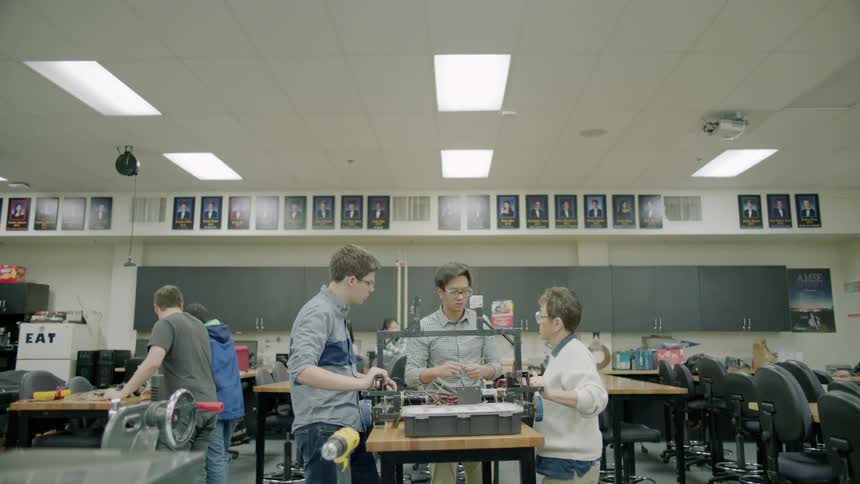 Children work on electronics in a classroom