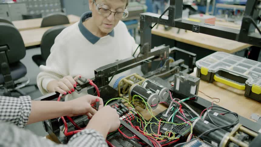 People work with electronics in a lab