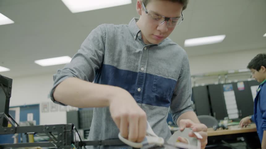 Children work on electronics in a classroom