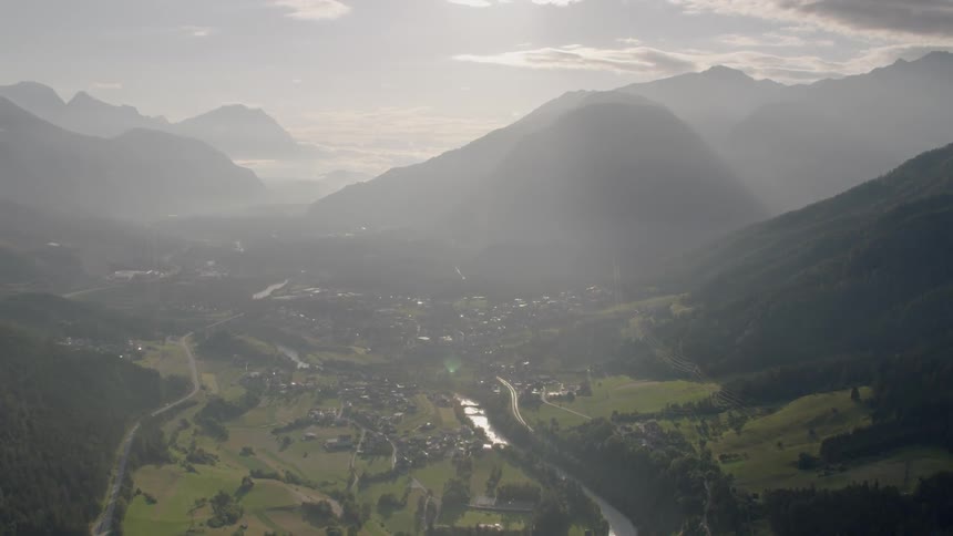 Clouds pass over tall mountains