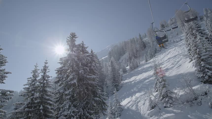 Ski lifts descend down the snowy slope