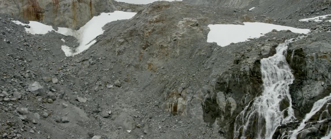 Water flows off the side of a cliff