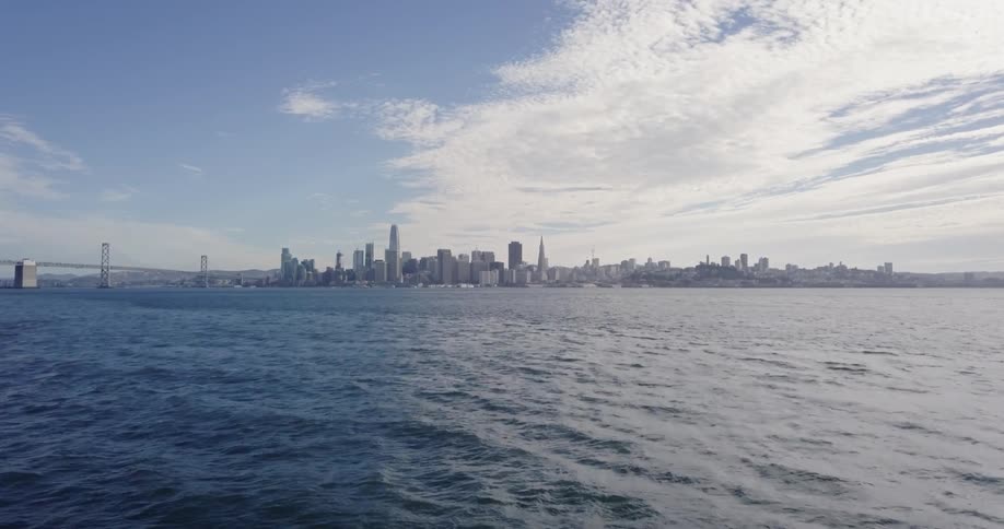 Past the large body of water is a city with many buildings