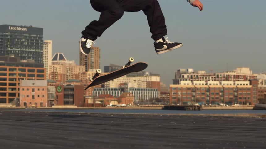 A man skateboards on a roof