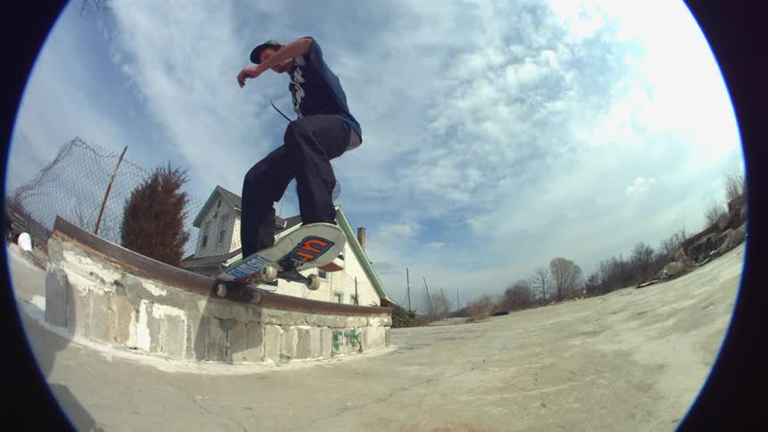 A skateboarder grinds a rail