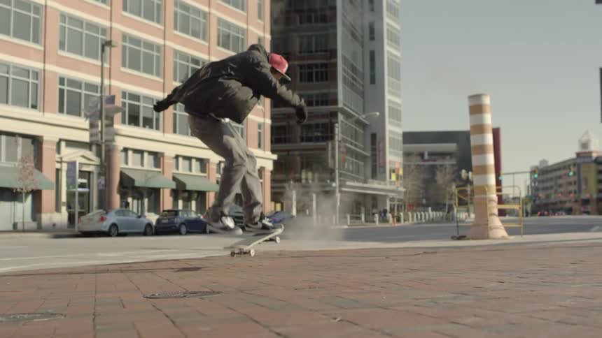 Steam pours from the street as a skateboarder performs a trick