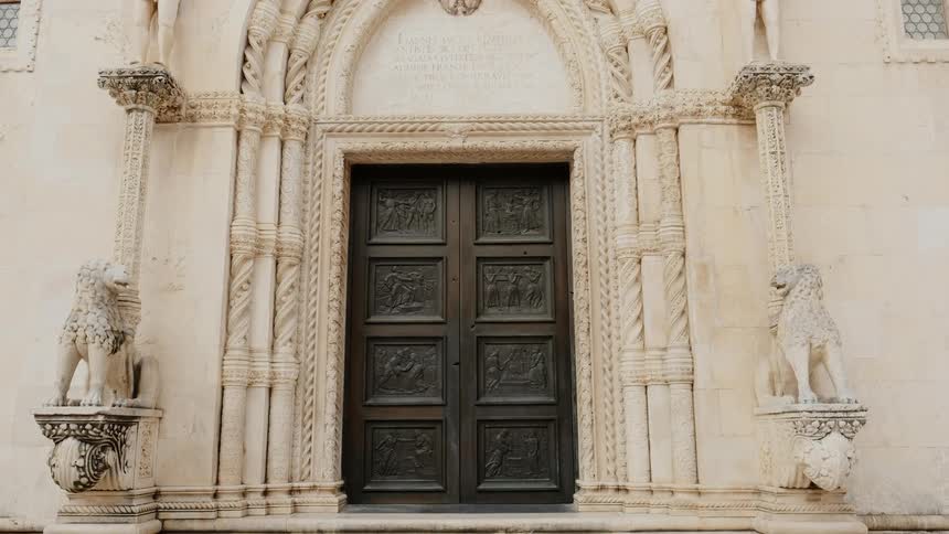 Birds fly over an ornate building entrance