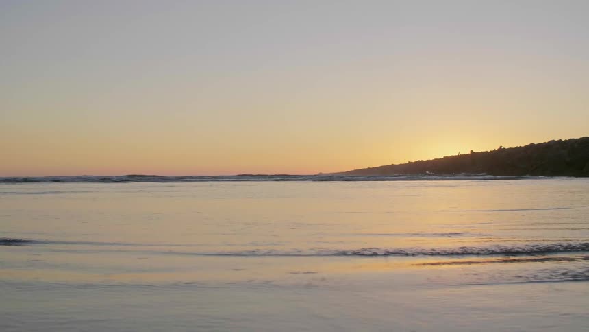 The sun is setting over the ocean
