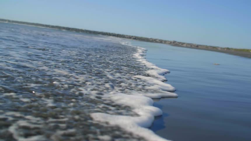 The tide flows onto the shore