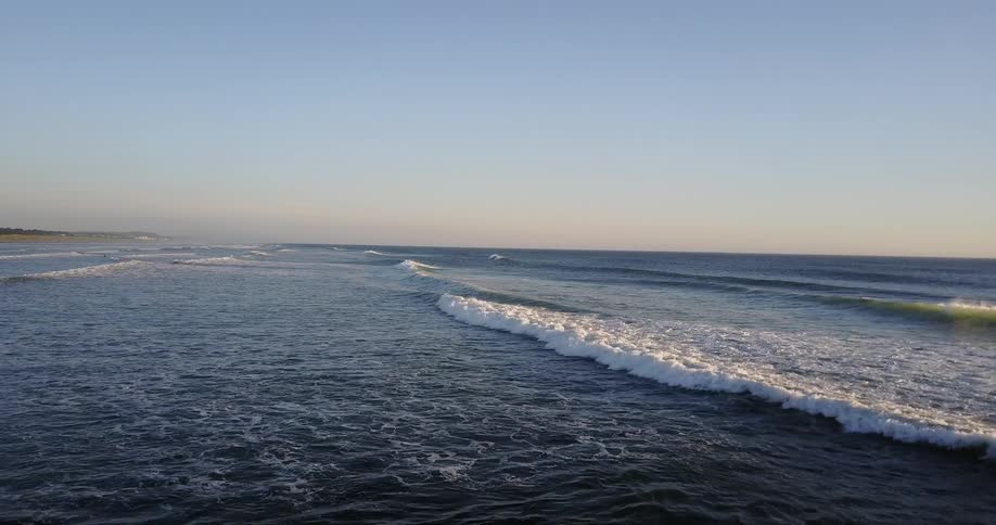 Waves are breaking onto the beach