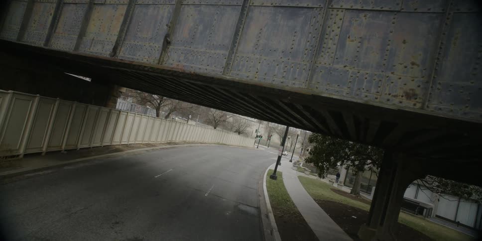A train passes over a city bridge