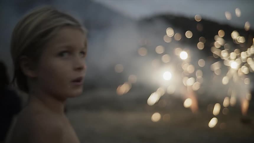 A kid is watching some fireworks