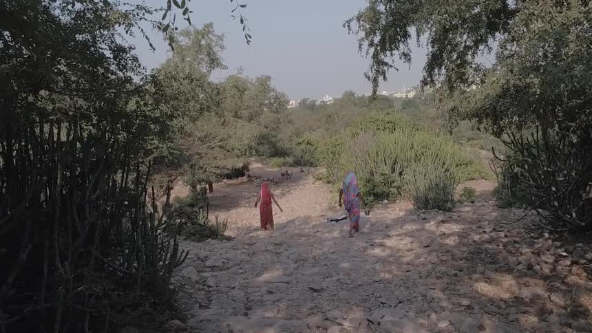 Two woman walk in a rural area