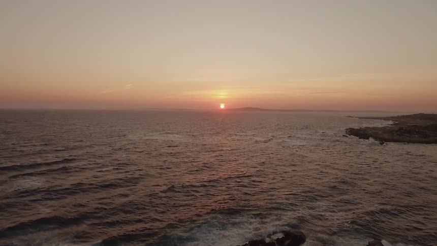 The sun sets over the ocean